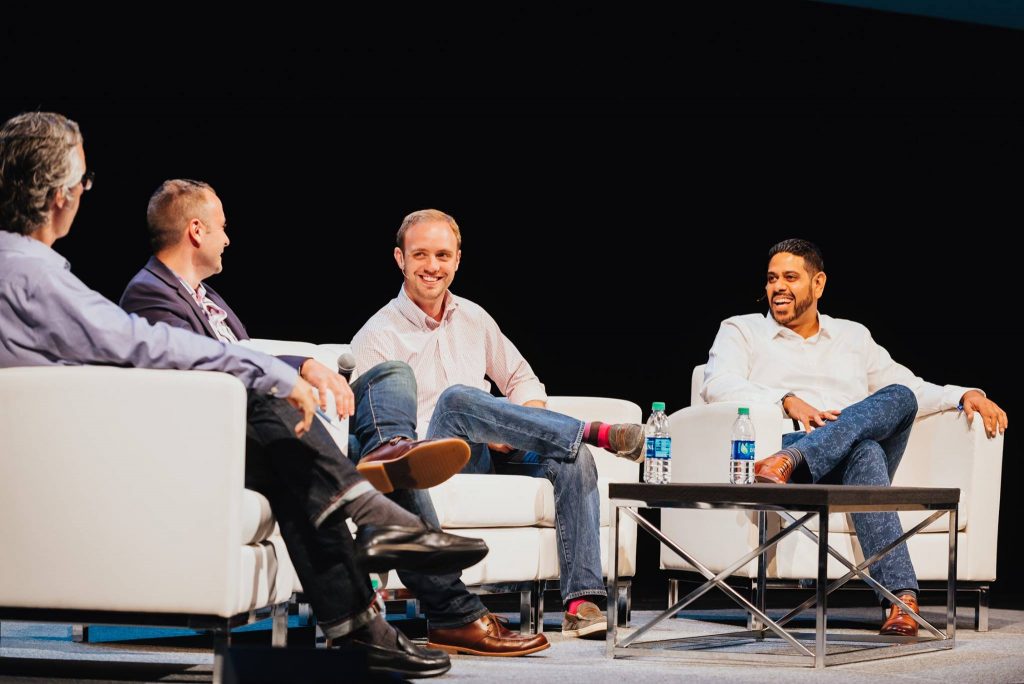Speakers chat at a fireside talk on stage at Postback 2016