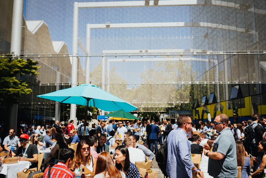 People relax in the sun outside a Postback event