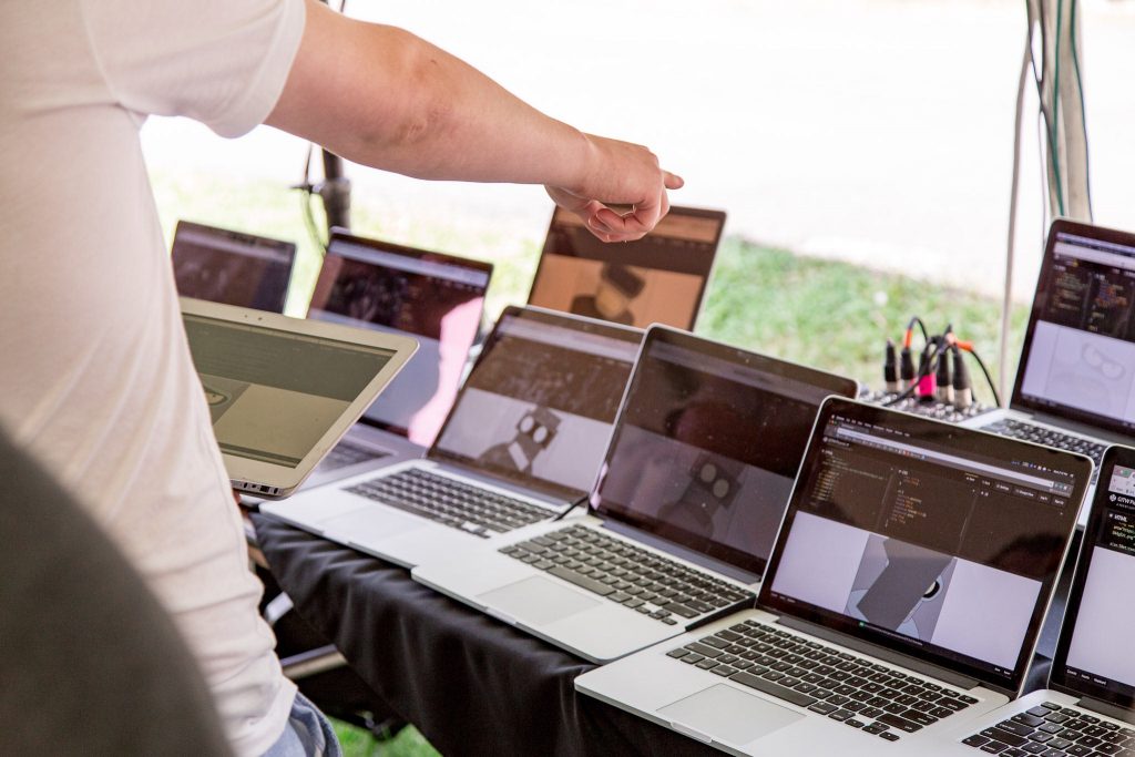 Man pointing at laptop computers