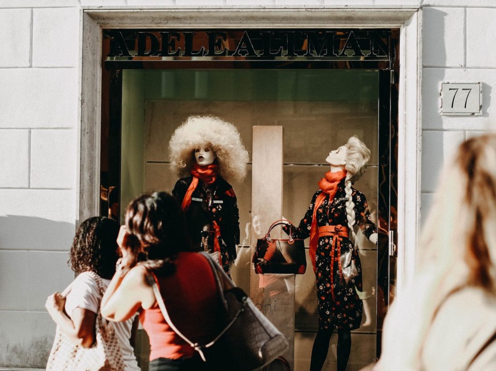 Consumers window shop outside a clothing retailer during the holiday season.