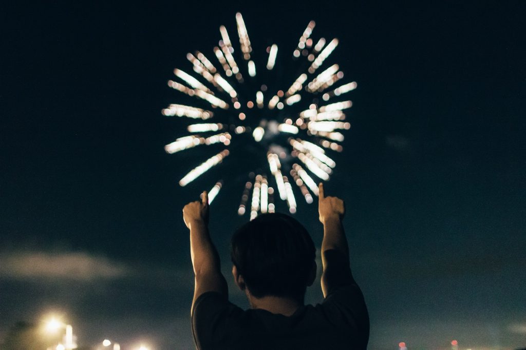 A man watches fireworks and celebrates the new year