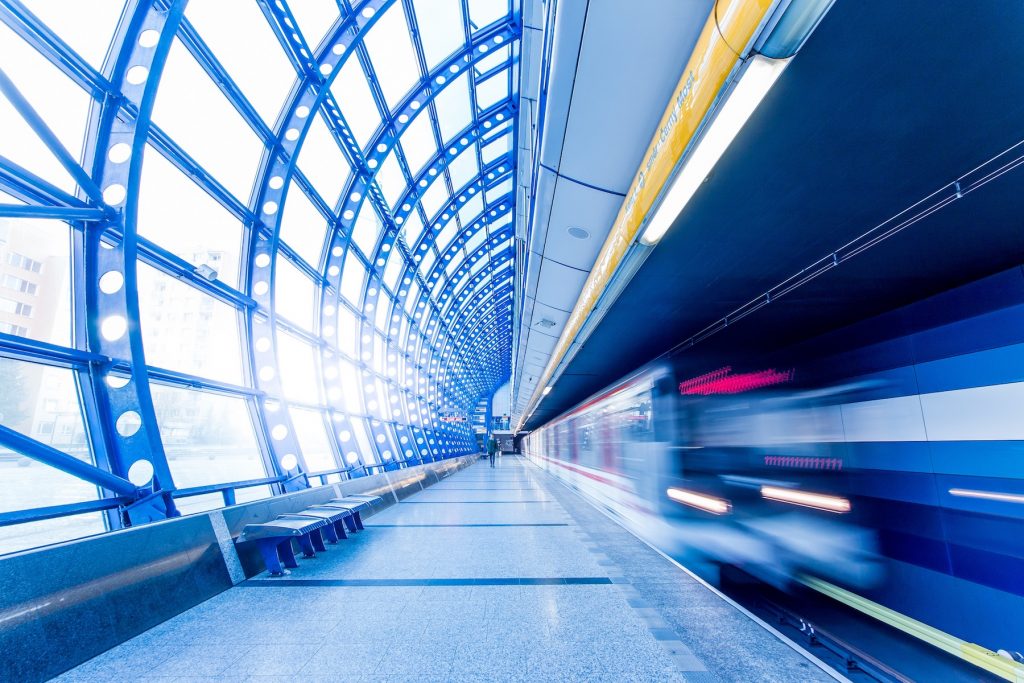 A commuter train passes a platform