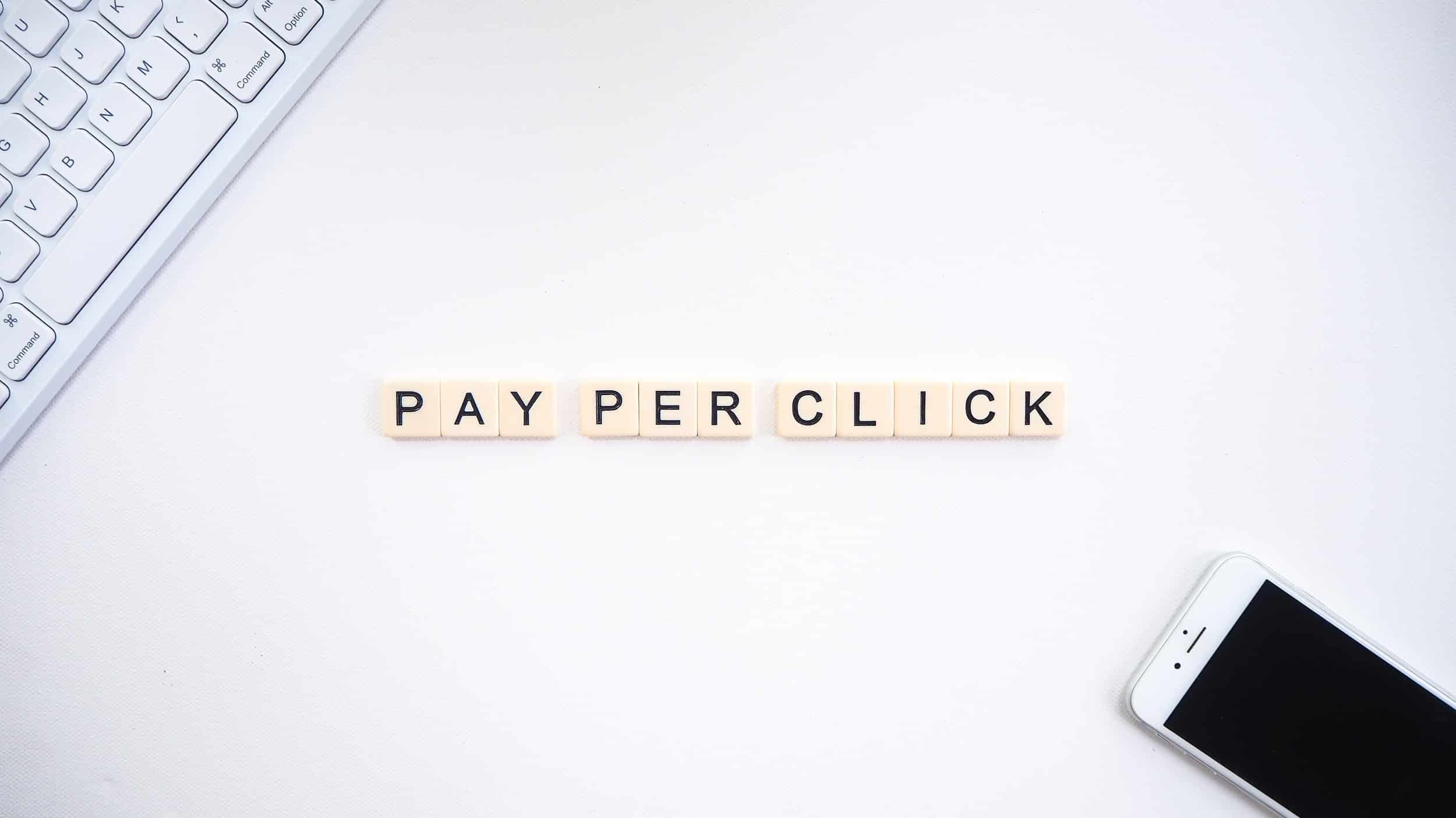 Pay per click (PPC) word tiles with a smartphone and computer keyboard