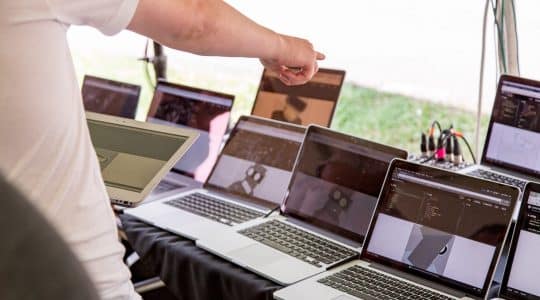 Man pointing at laptop computers