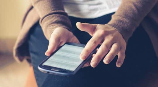 A woman browses a native advertisement on her phone