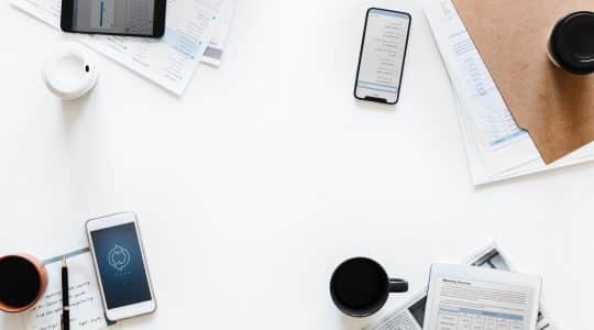 Business items laying on white background