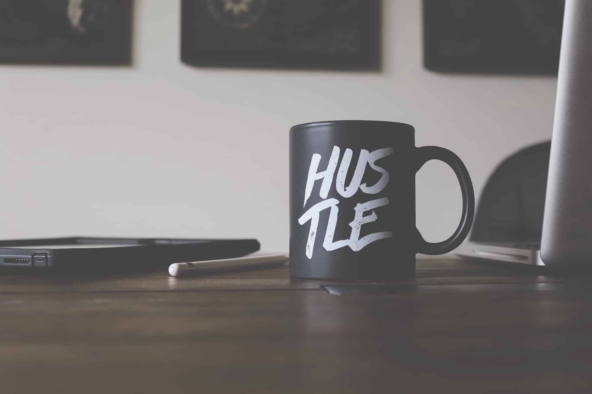 Mug in marketing office that reads "Hustle."
