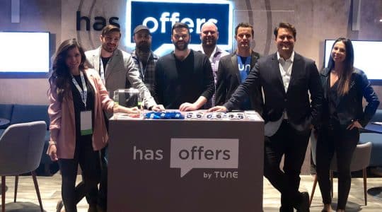 The HasOffers by TUNE team poses in front of their booth at Affiliate Summit West 2019