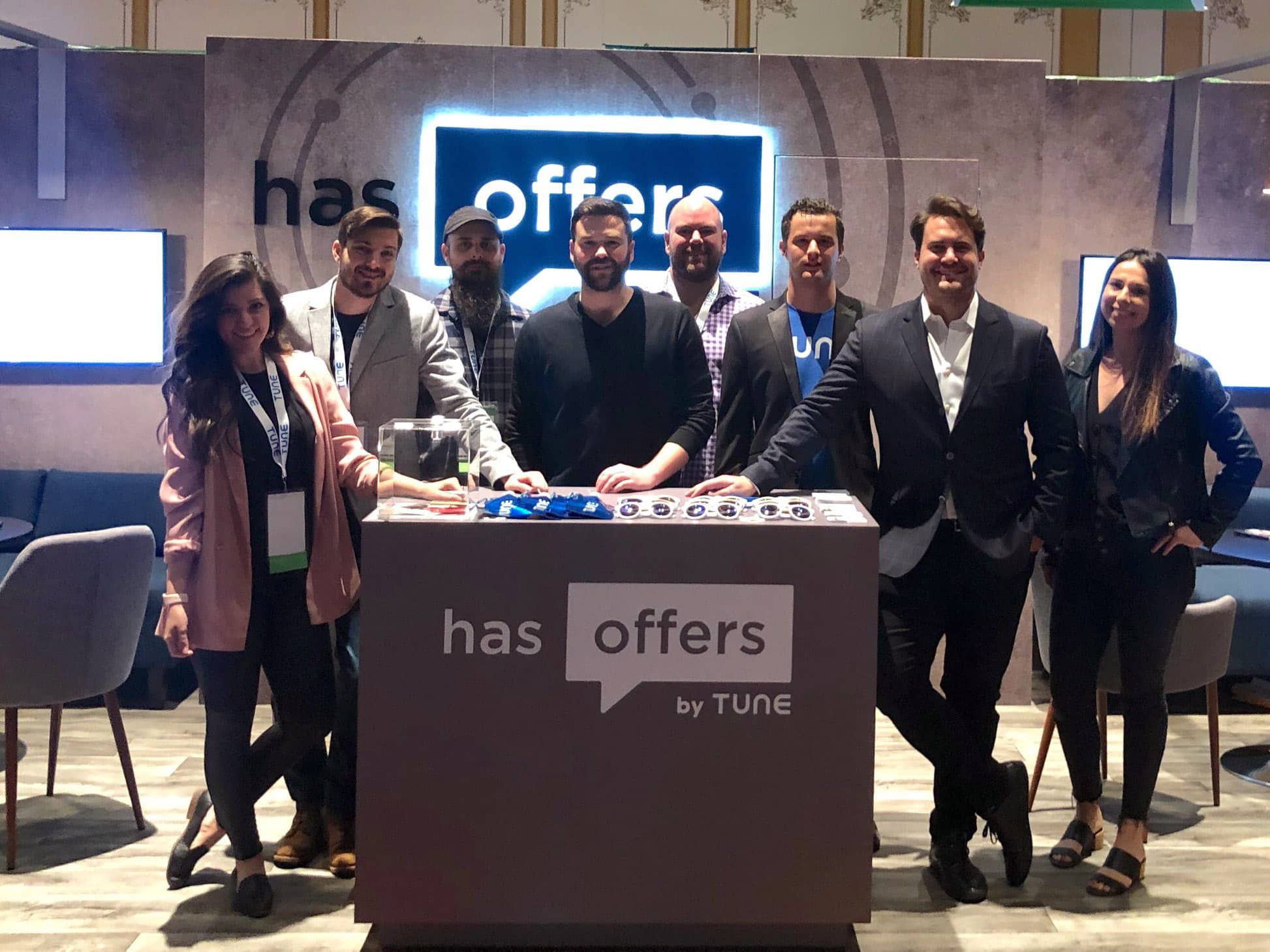 The HasOffers by TUNE team poses in front of their booth at Affiliate Summit West 2019