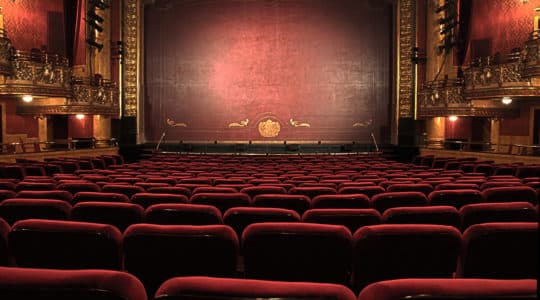 Image of a theater stage and seats