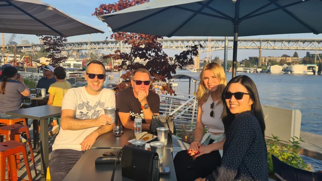 Members of TUNE's CSM team grab a snack in the sun on the way to the 2022 TUNE retreat