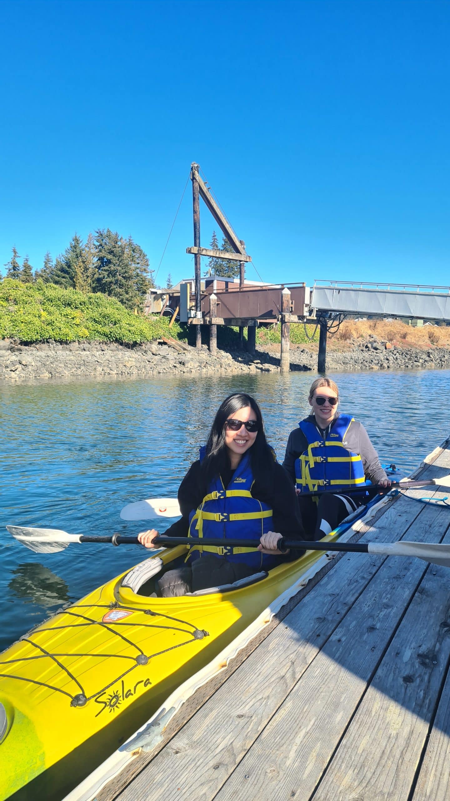 Soyoon and Iana in a double kayak and ready for adventure at the 2022 TUNE retreat