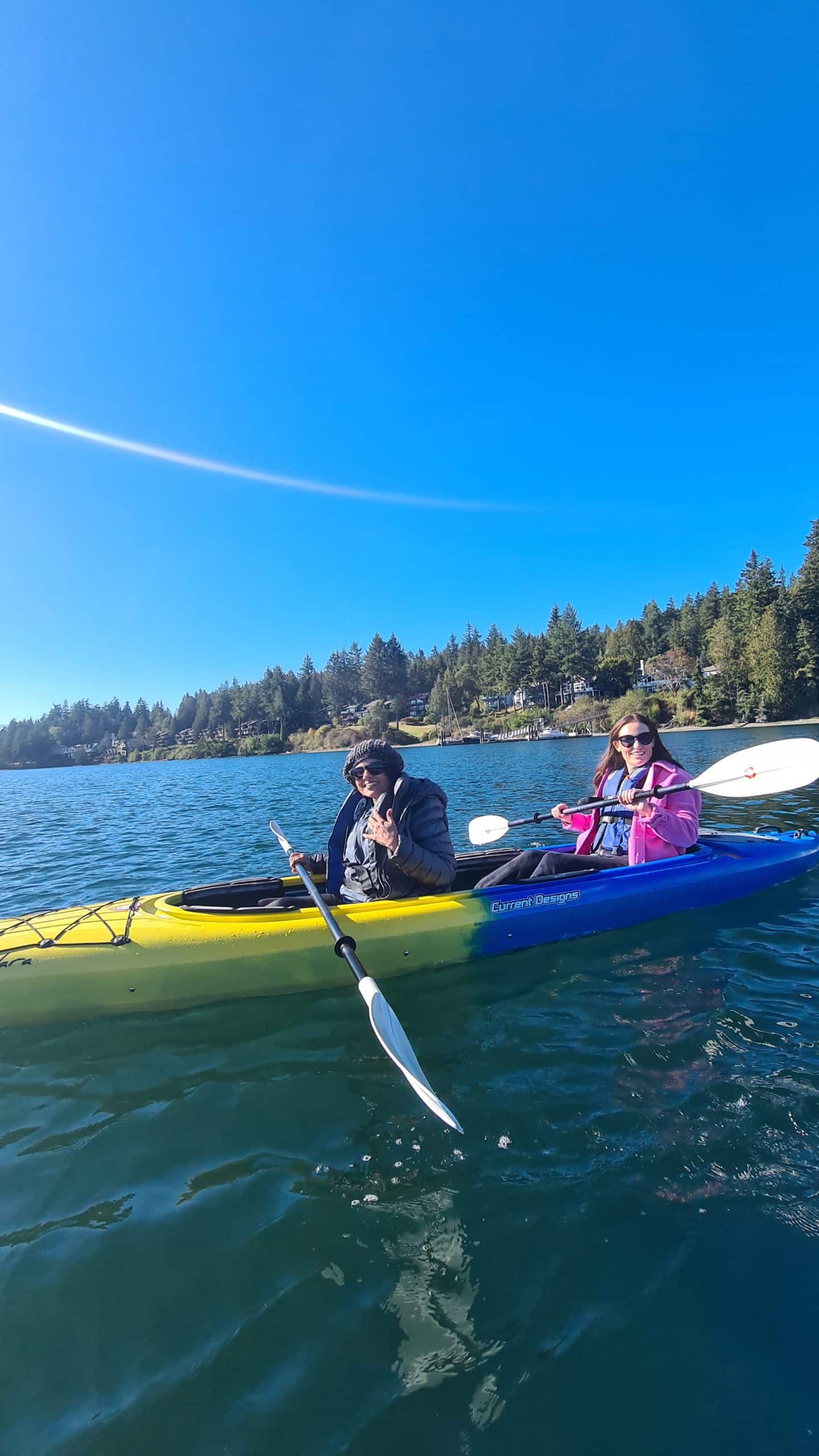 Sadhana and Lyndsey share a kayak during the 2022 TUNE retreat