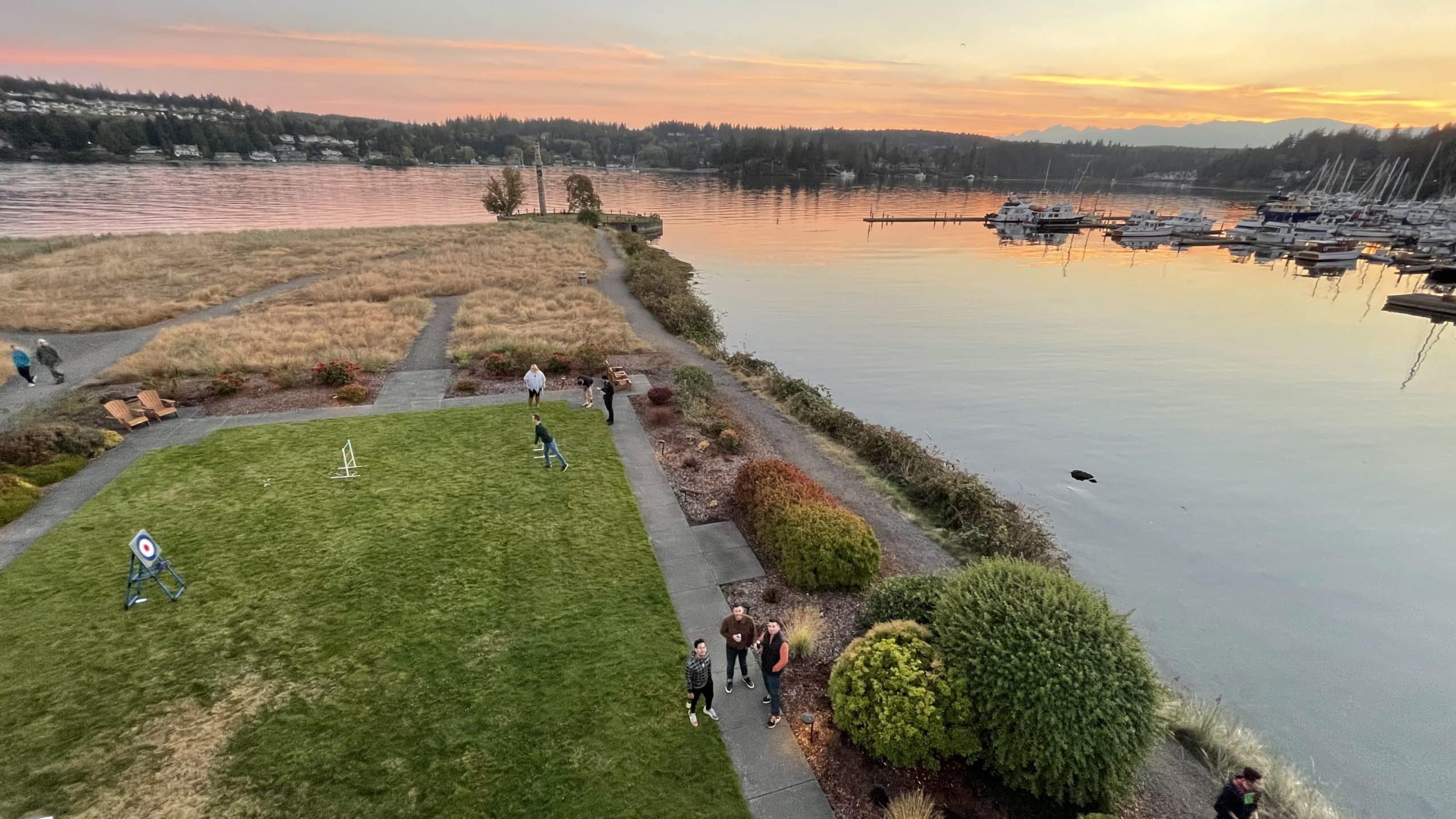TUNE employees hang out on the lawn and watch the sunset during the retreat